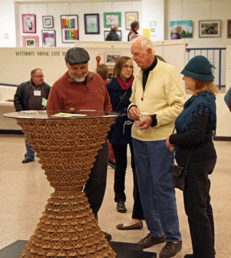 Viewers appreciating American Black Walnut Table by Albert Tanko of North Branch