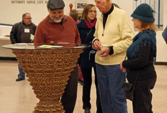 Viewers appreciating American Black Walnut Table by Albert Tanko of North Branch